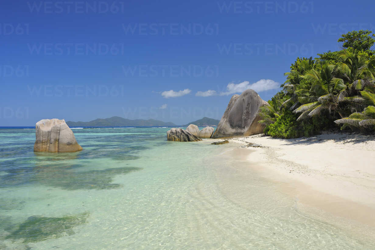Seychelles La Digue View To Anse Source D Argent With Sculpted Rocks And Palm Trees Stockphoto