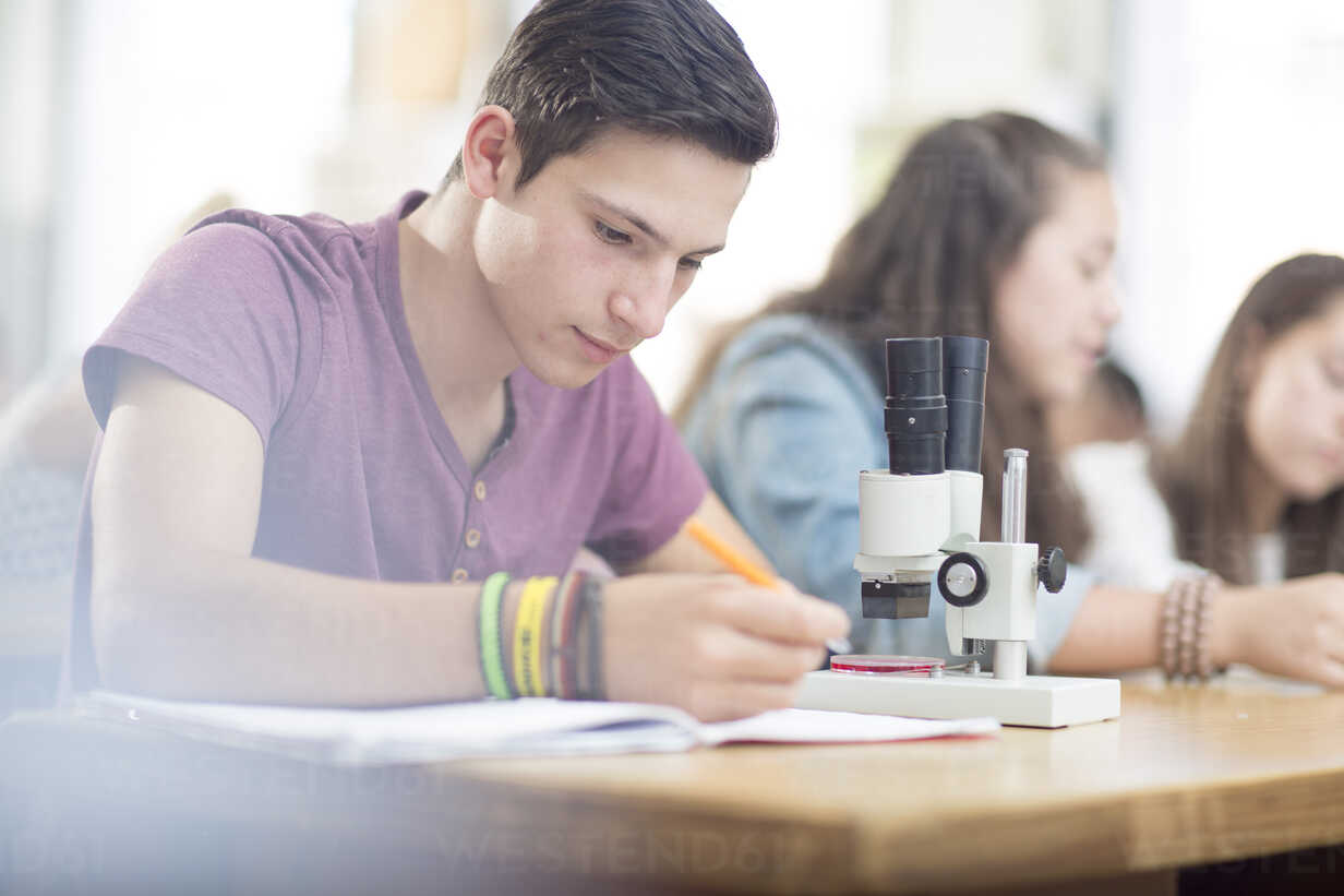 Science Student Working In Class With Microscope Zef12647