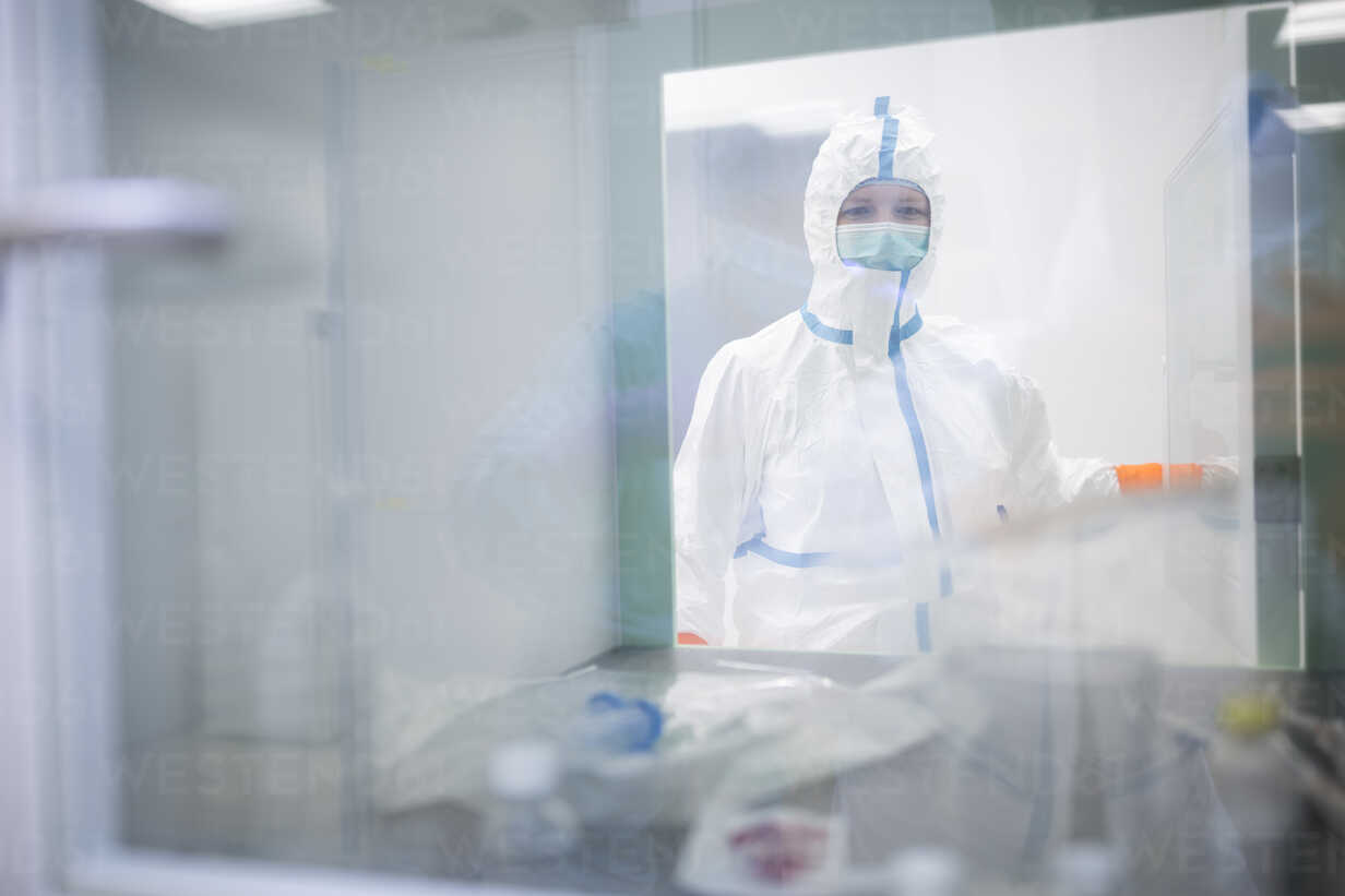 Lab Technician Wearing Cleanroom Overall At Material Sluice