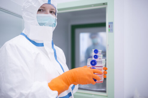 Lab Technician Wearing Cleanroom Overall At Material Sluice