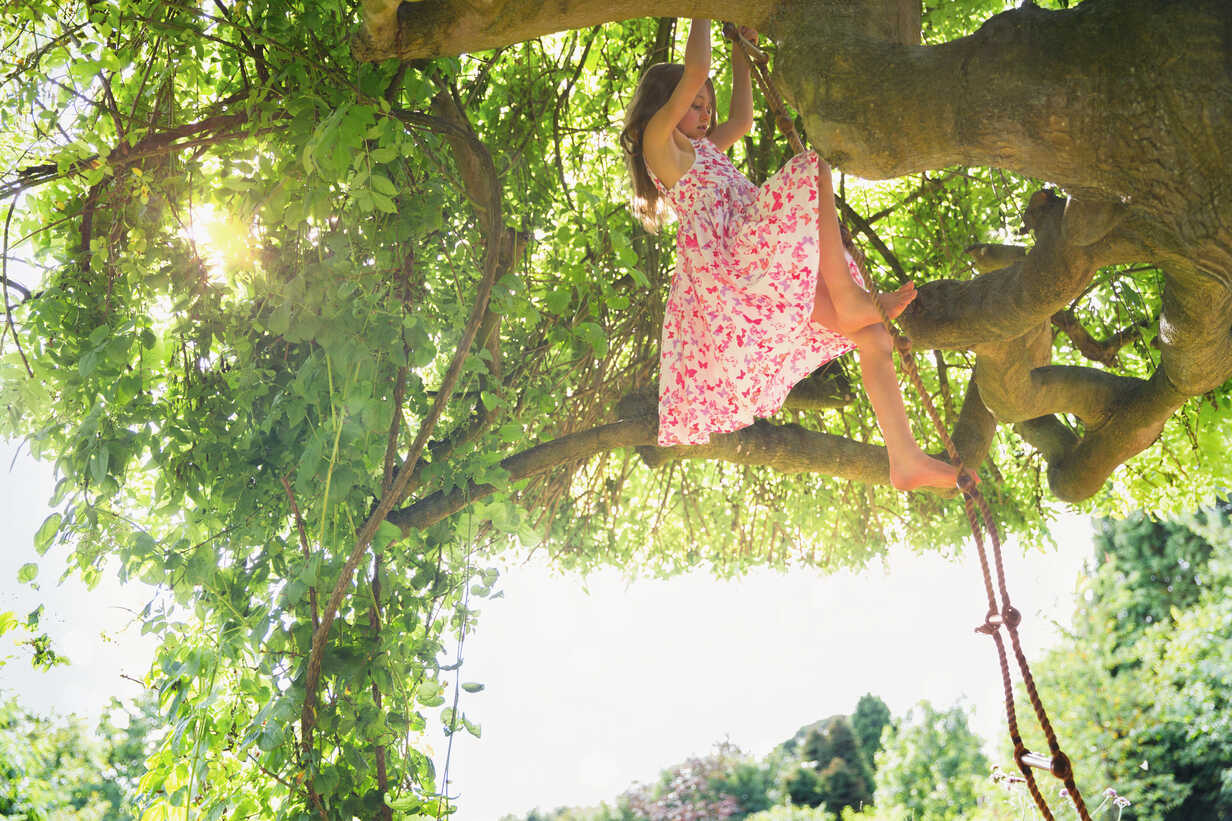 Barefoot girl Climbing on the Tree