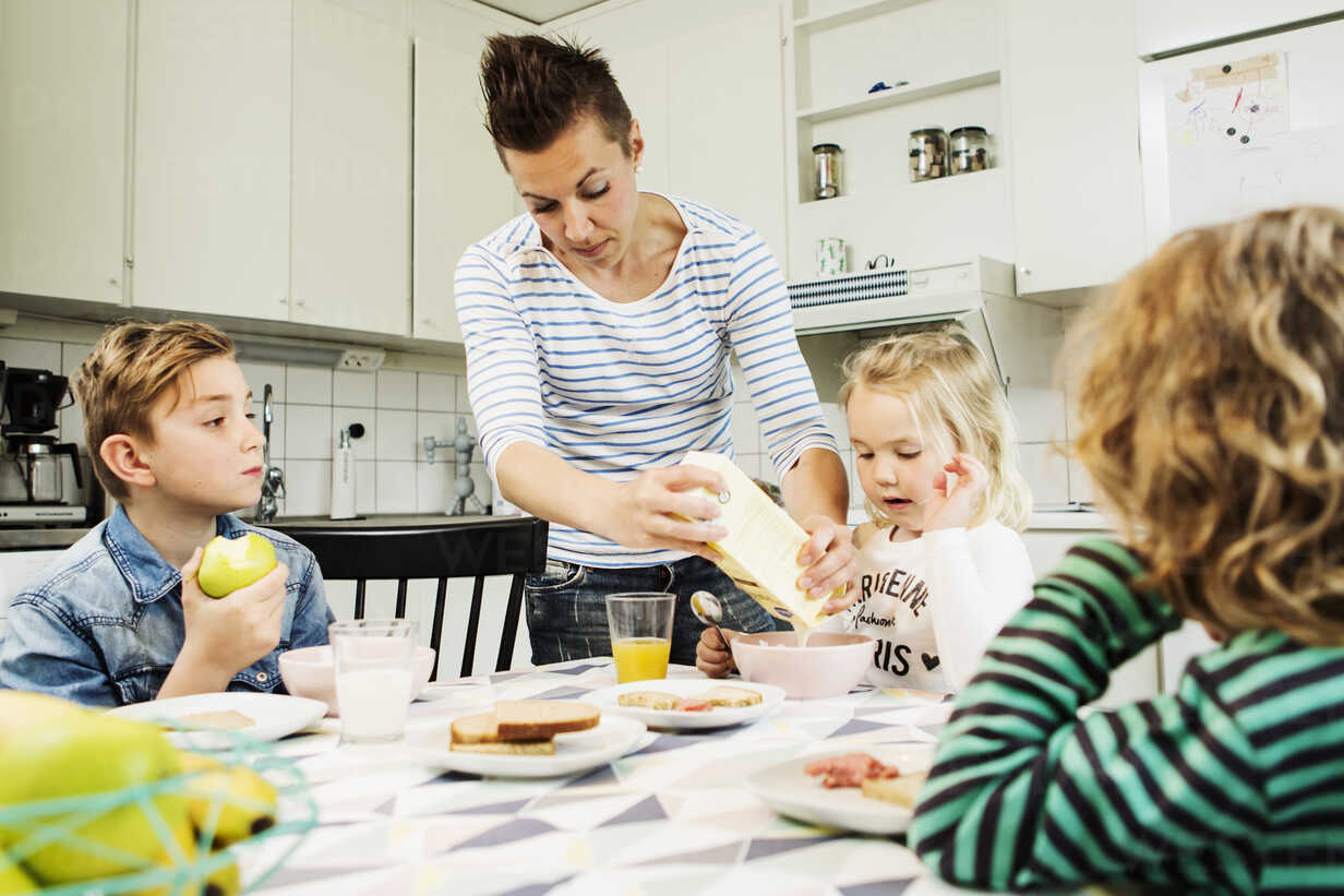 Mother Serving Breakfast To Children At Dining Table In Kitchen Masf04178 Kentaroo Tryman Westend61