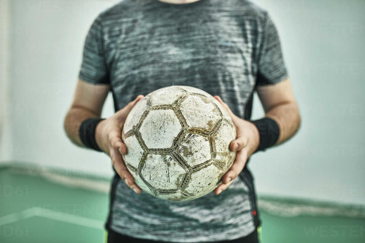 Close Up Of Indoor Soccer Player Holding The Ball Stockphoto