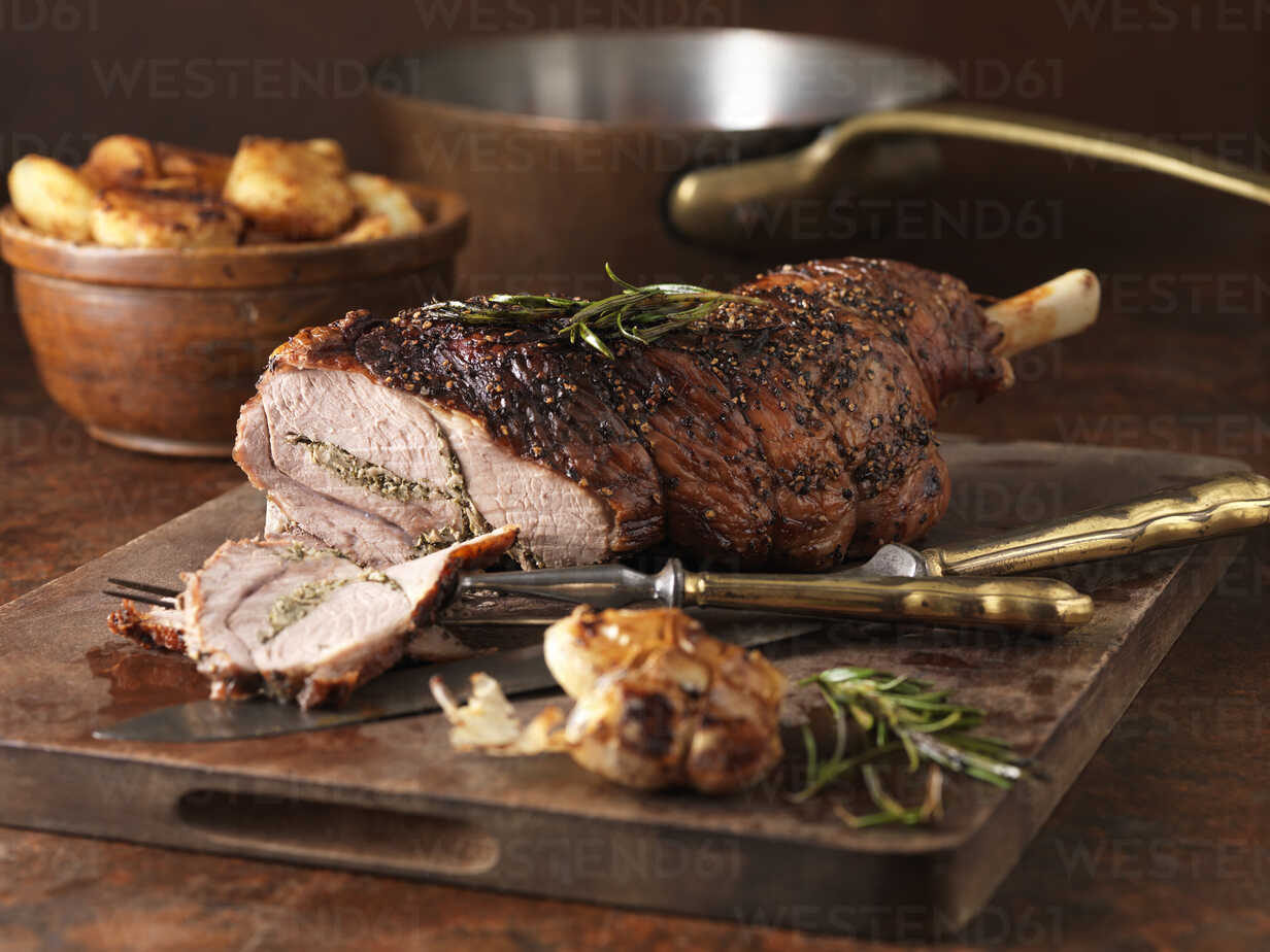 Christmas Dinner Roasted Rosemary And Garlic Leg Of Lamb And Roast Potatoes Stockphoto