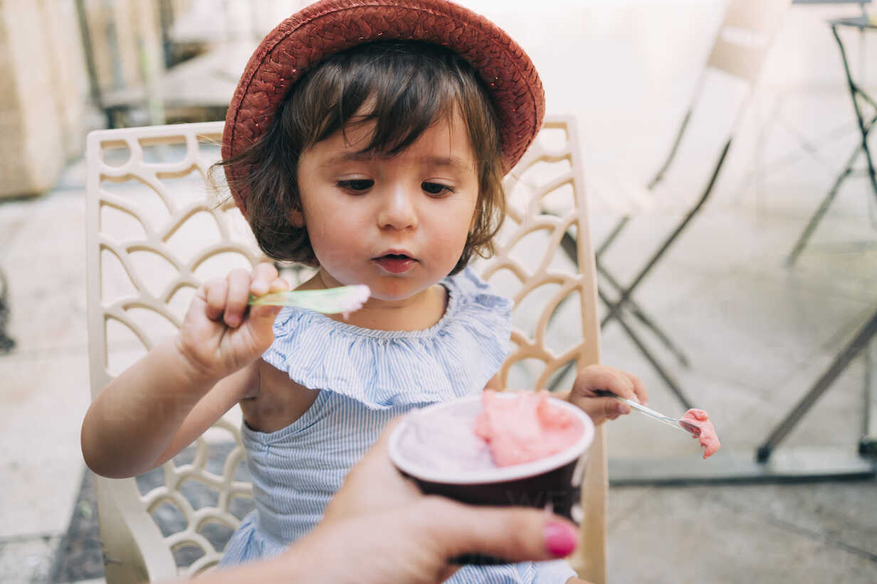 Cute Toddler Girl Eating An Ice Cream Held By Her Mother Gemf02113 Gemma Ferrando Westend61