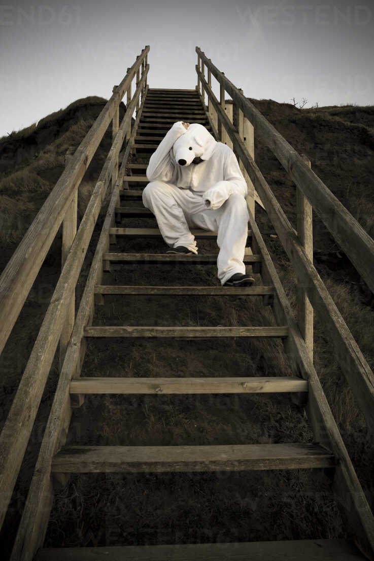 Man Wearing Ice Bear Costume Sitting On Steps Despair Reaf Realitybites Westend61