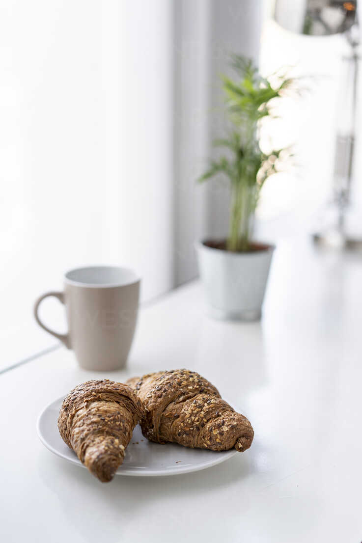 Croissants And A Cup Of Coffee In An Office Stockphoto