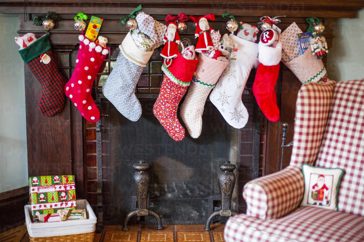 Stuffed Christmas stockings over fireplace - BLEF08072 - Adam  Hester/Westend61