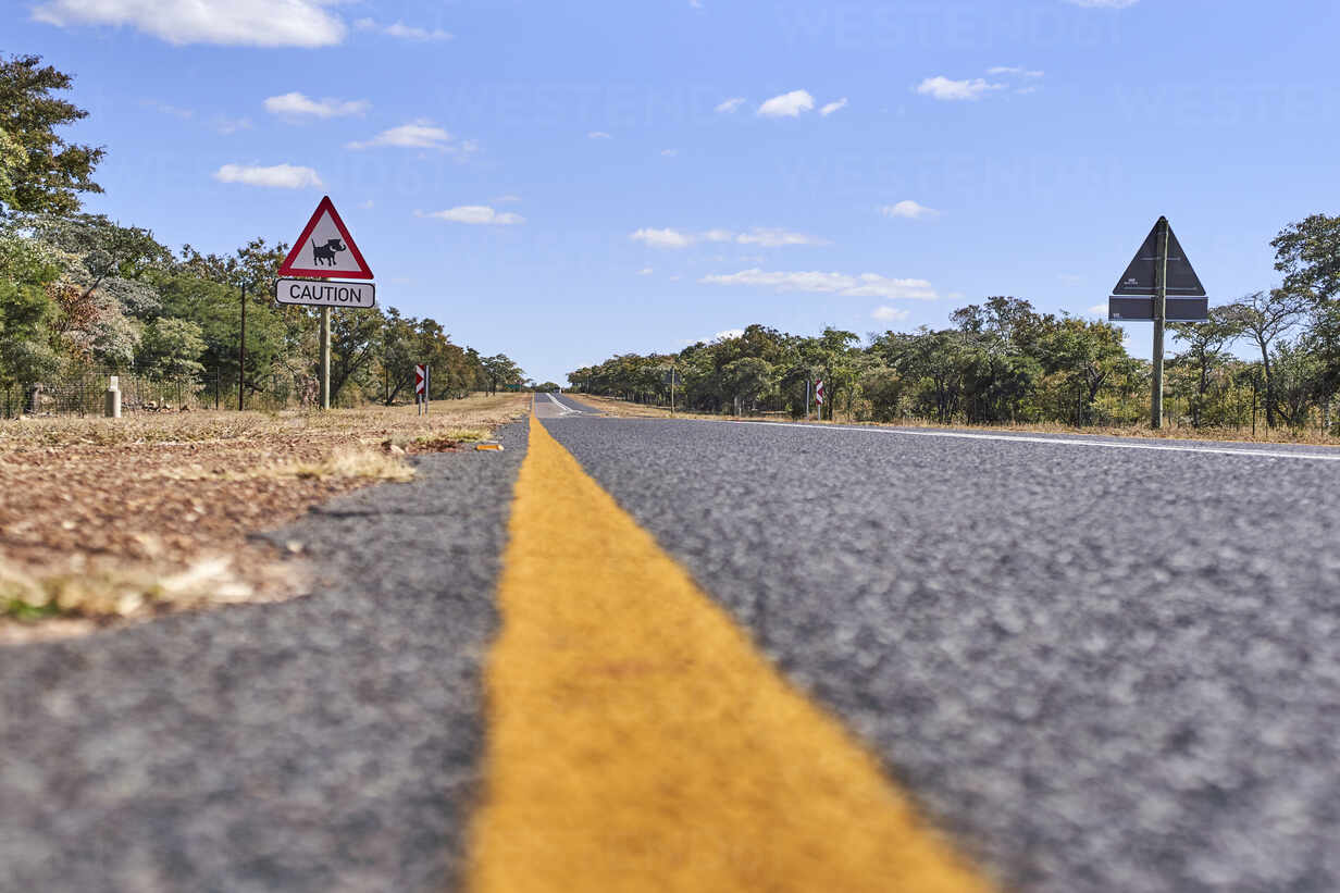 Surface Level Of Warthog Crossing Sign By Road Against Sky Mpumalanga South Africa Vegf Veam Westend61