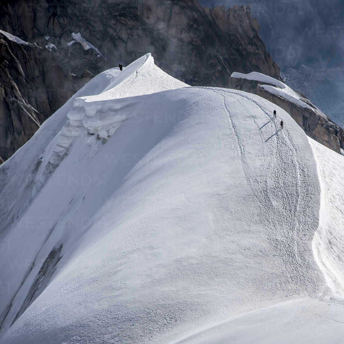 Looking Down The Ridge Into The Vallee Blanche Where A Small Group Of Climbers Are Heading