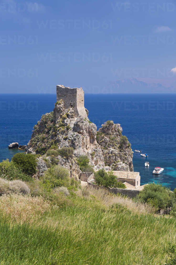 View Across Field To Ruined Medieval Watchtower On Cliffs Above The Gulf Of Castellammare Scopello Trapani