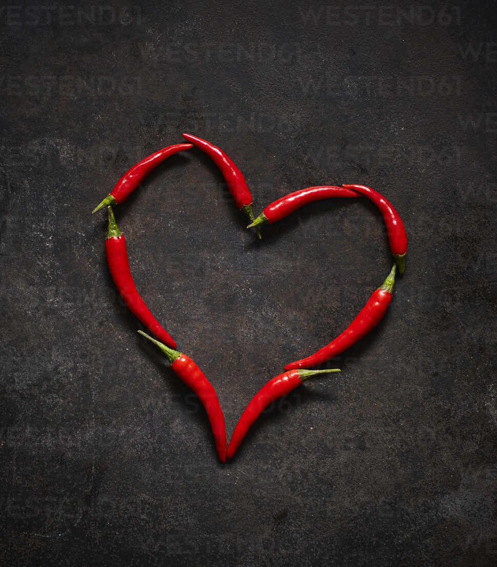 Red chili peppers arranged in heart shape - KSWF02127 - Kai Schwabe ...