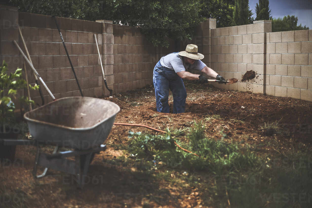 Man Digging Soil In Backyard Stockphoto