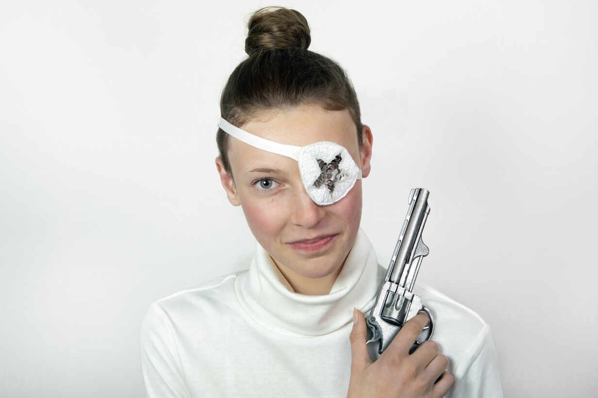 Portrait Of Teenage Girl With Revolver Wearing Eye Patch Pstf Petra Stockhausen Westend61