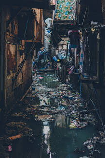 View Of Narrow Dirty And Grungy Street Flooded With Water And Trash Floating On Top Adsf Addictive Stock Creatives Westend61