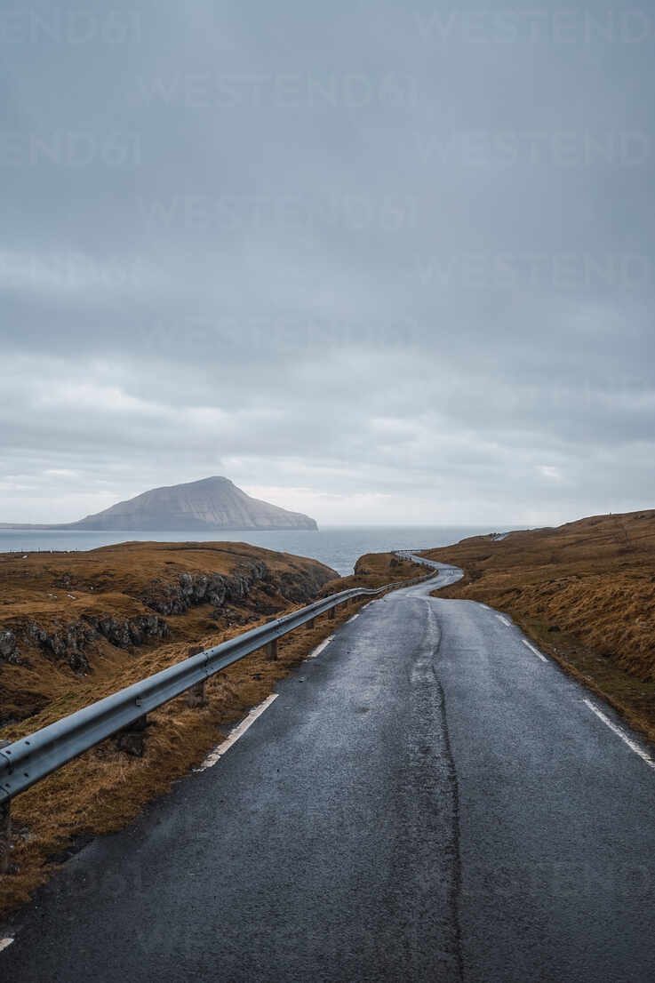 Curvy Asphalt Road Going Through Hilly Terrain On Cloudy Day On Faroe Islands Adsf076 Addictive Stock