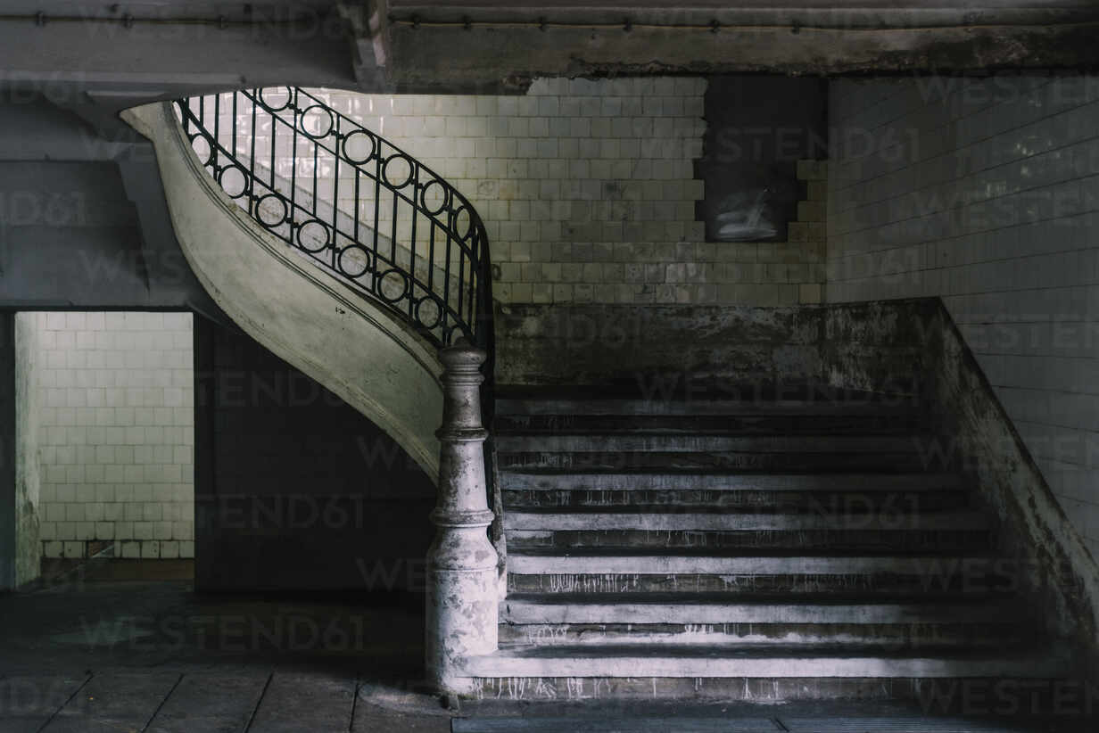 Interior Of Shabby House With Stone Stairway With Metal Railing And Tiled Walls Stockphoto