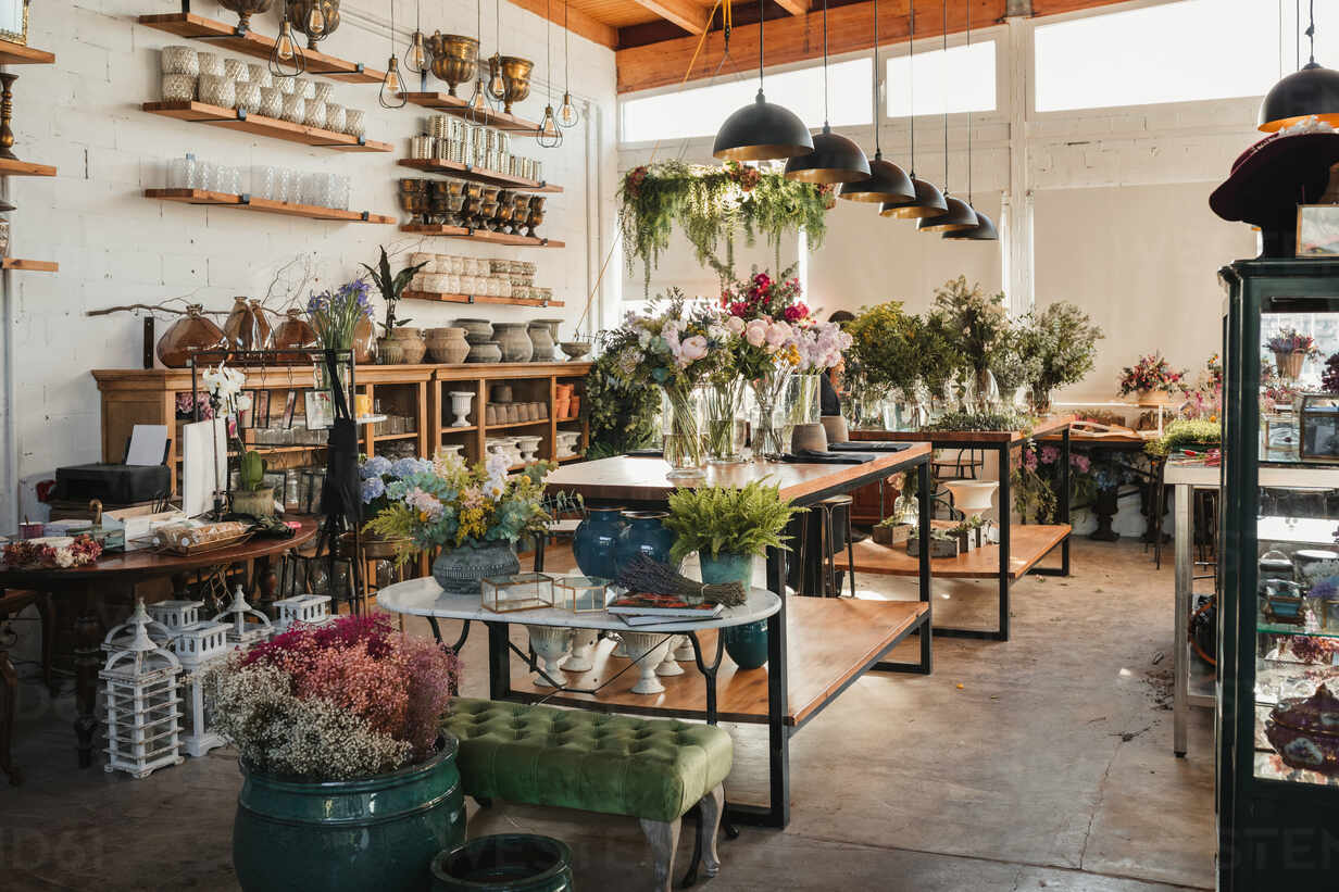 Interior Of Modern Floral Shop With Various Bouquets And Decorative Pots And Vases Arranged On Wooden